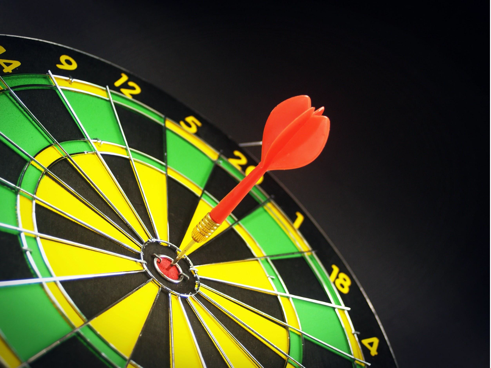 A dart board with a dart in the bullseye